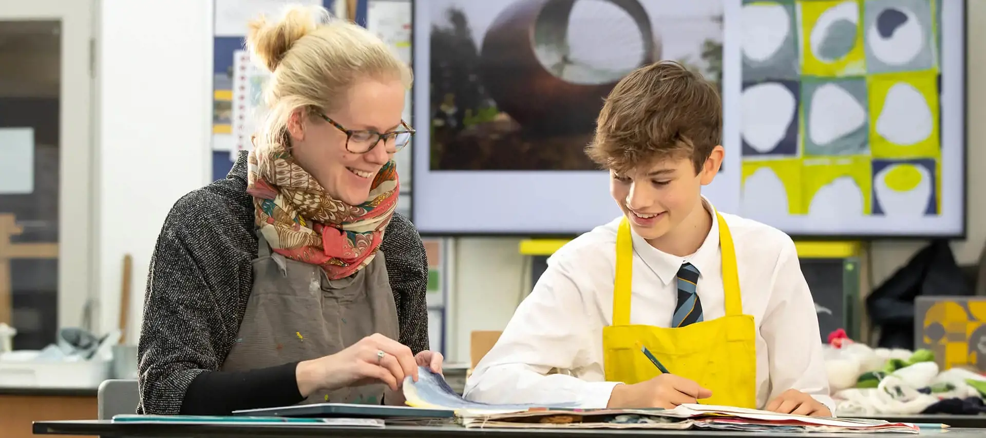 Student and teacher working together in art class at The Gregg School