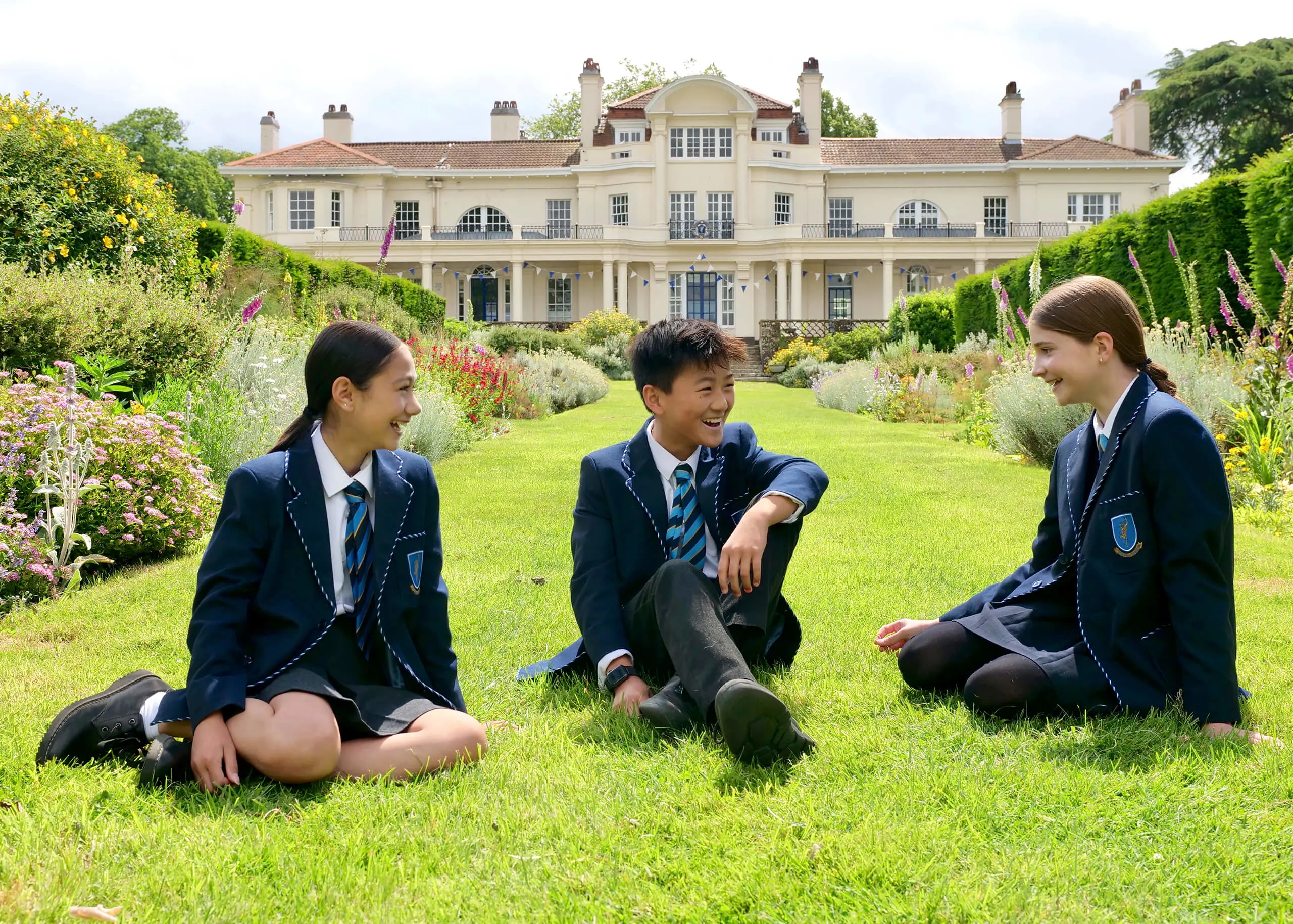 Pupils sitting in the school grounds 